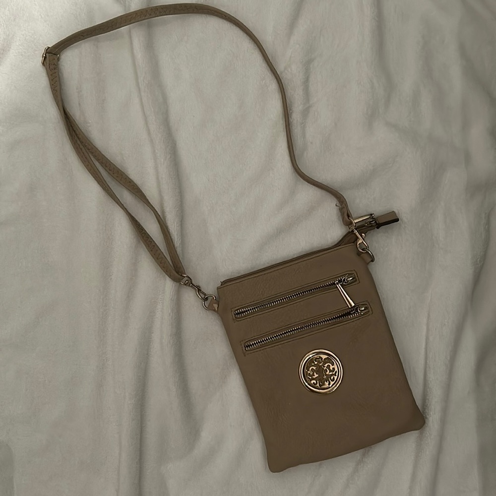 a purse perfect for traveling, tan color, with many compartments